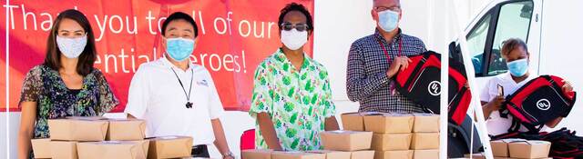 UL workers handing out items at event