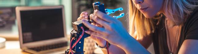 Person working in a robotics workshop