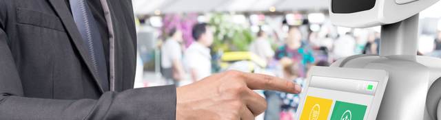 Businessman using autonomous personal assistant robot for navigation at the airport