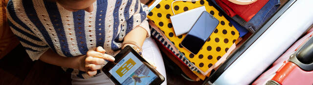 Upper view of a woman in white pants and striped blouse at modern home on the phone.