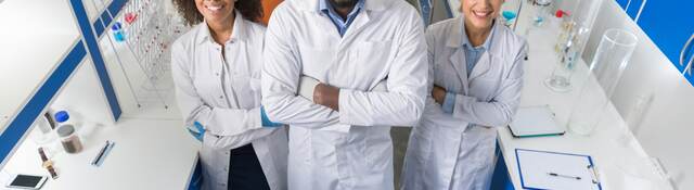 African American Scientist With Group Of Researchers In Modern Laboratory Happy Smiling, Mix Race Team Of Scientific Researchers In Lab.