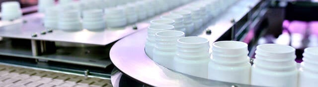 White plastic bottles on a production line