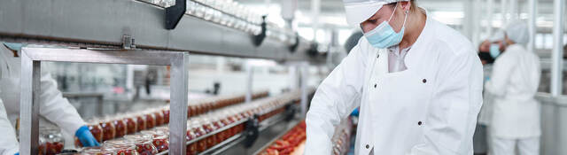 Person working with food on a production line