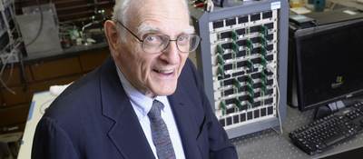 John Goodenough sitting in his lab in front of lab equipment