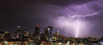 Nighttime skyline with lightning striking a building