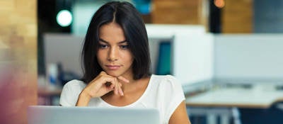 Woman sitting at her desk creating a compliant SDS. 