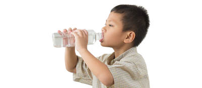 A boy drinking from a water bottle. 