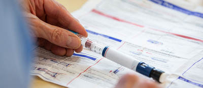 Person holding a needle