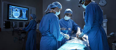Surgeons with  a patient in an operating room