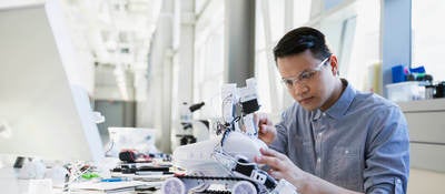 Worker working on a small robot
