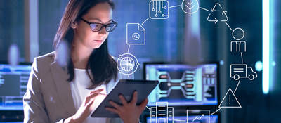 Photo of a woman in a lab working on a tablet