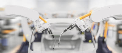 Car being built on assembly line in factory with robot arm adding parts to car