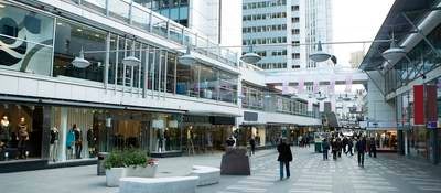 people walking between buildings