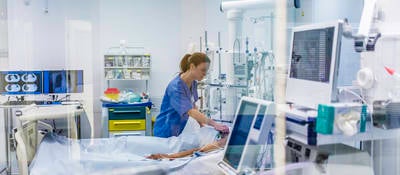 Doctor using electrode on patient in emergency room