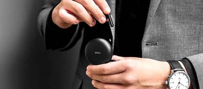 Man holds LG TONE Free™ wireless earbuds case in his hands
