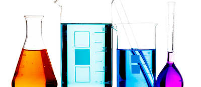 Lab beakers containing different colored liquids
