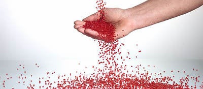 Hand catching plastic pellets