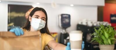 Foodservice worker following safety guidelines and wearing proper safety equipment