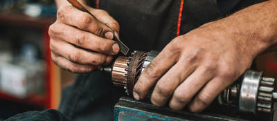 Manual worker repairing electric motor in a workshop