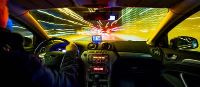 Car interior lights and exterior traffic lights on the roadway