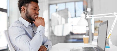 Man sitting in front of computer doing online training