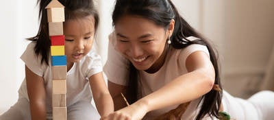 Mother and child playing with toys together