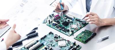 Lab tech working on electronic device