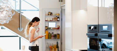 Woman looking into her fridge