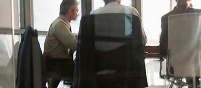 Business people in a modern all glass made meeting room