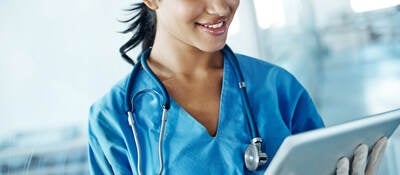 Nurse looking at a tablet