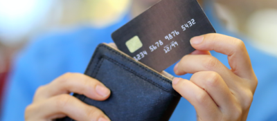Woman pulling a credit card out of a wallet