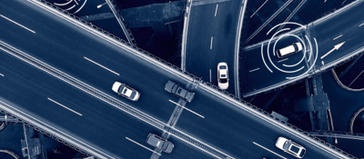 Close -up of a car driving in a city at dusk