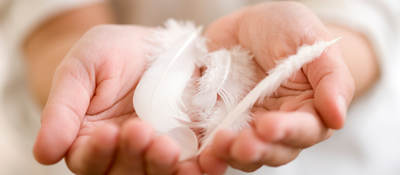 Woman holding feathers and downs