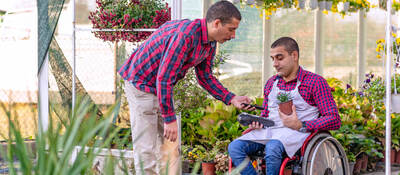 man paying with a mobile phone in flower shop