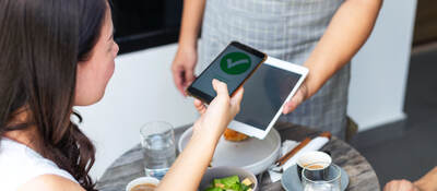 woman using a mobile phone for payment