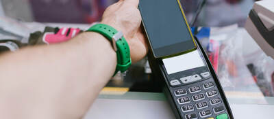 man tapping a mobile phone for payment