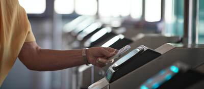 man tapping a card to open the gate