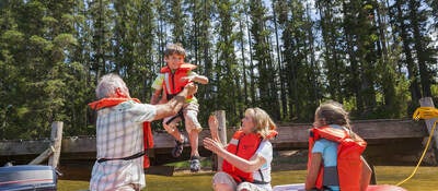 A family going boating wearing life vests