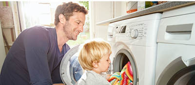 Father and son doing laundry