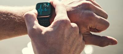 Man checking heart rate on a smart watch