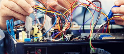 Electronics engineer repairs an audio/video device
