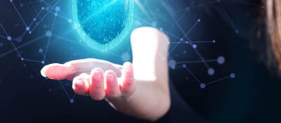 Human hand with transparent shield floating over palm