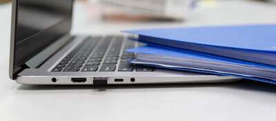 Folders and laptop on a desk.
