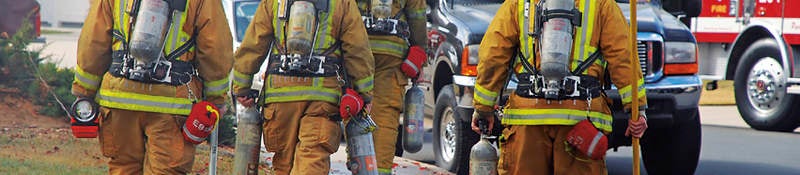 firefighters next to their truck