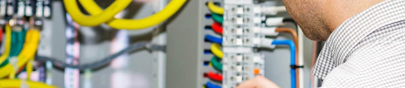 Electrical engineer working in electrical cabinet
