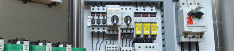 An opened industrial control panel showing components