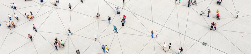 Groups of people standing being connected by lines on the ground.