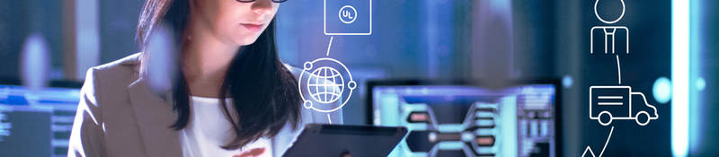 Photo of a woman in a lab working on a tablet