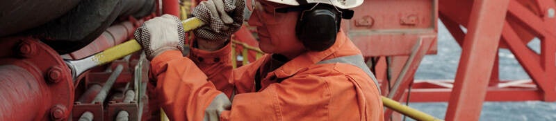Working in a hard hat working in a petroleum refinery
