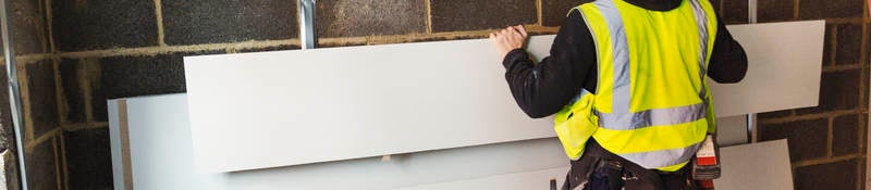 Construction worker using drywall